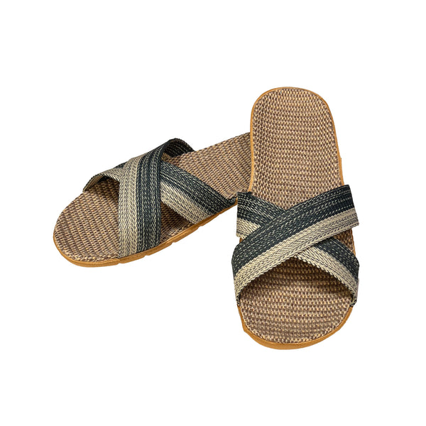Pair of woven sandals with striped straps on a white background