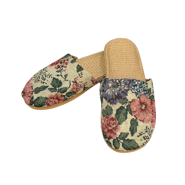 Pair of floral-patterned slippers on a white background