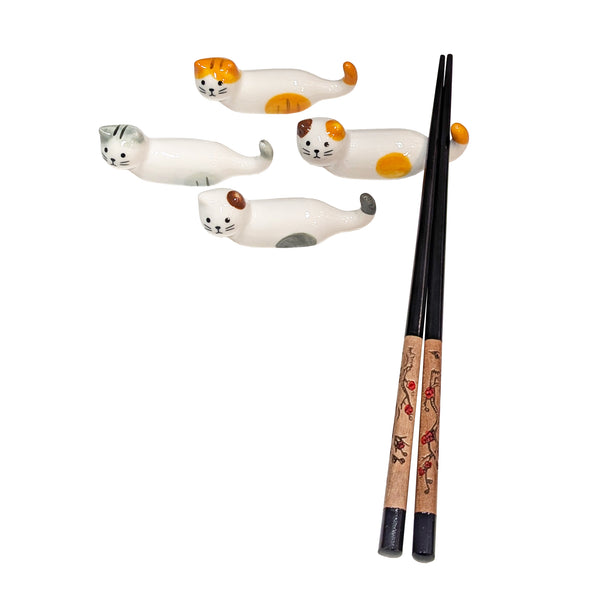 Four ceramic cat chopstick holders with different color patterns and one pair of chopsticks