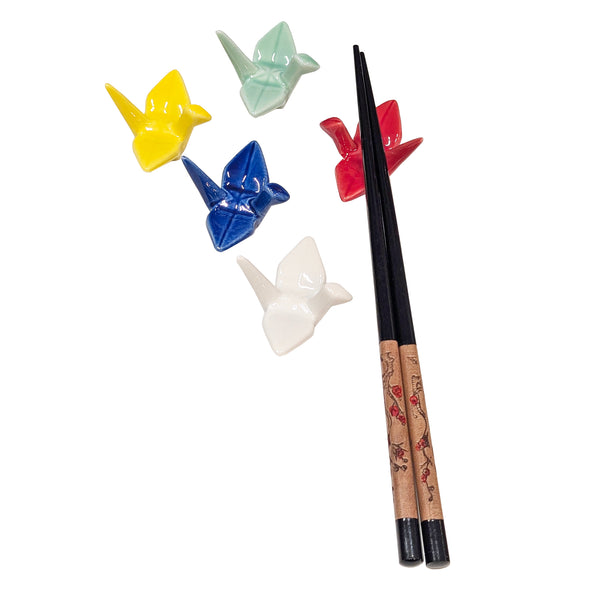 Yellow, green, red, blue, and white crane chopstick rests with one pair of chopsticks