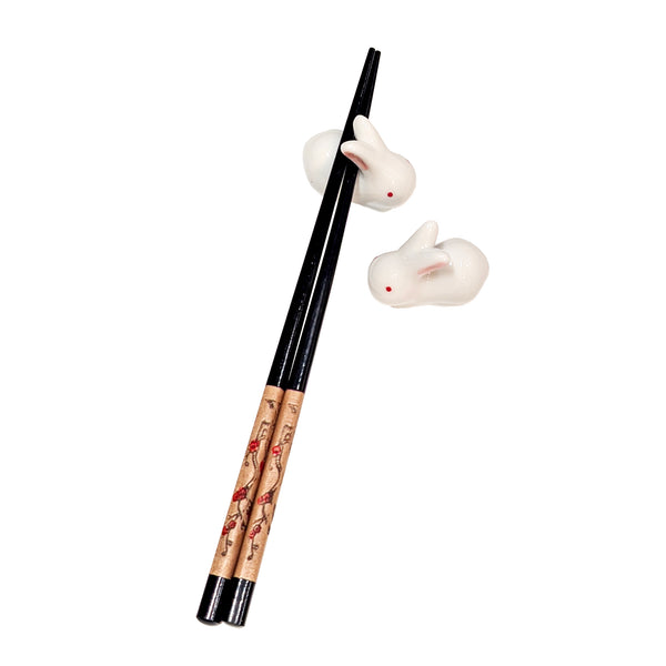 Two white rabbit chopstick rests with one pair of chopsticks